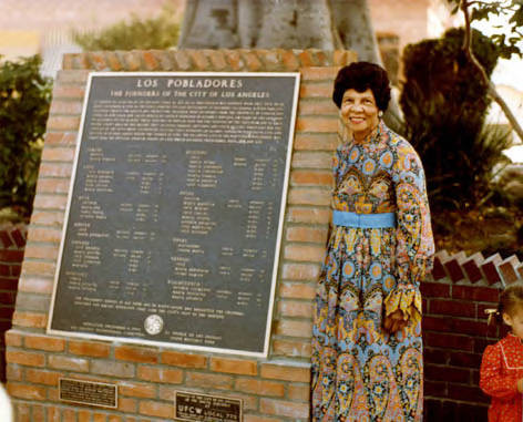 Founders Plaque with Miriam Matthews standing to the right of it