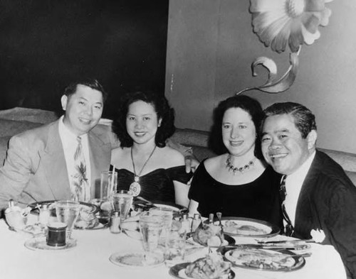 Mr. and Mrs. James Wong Howe (Sanora Babb Howe) dining with friends