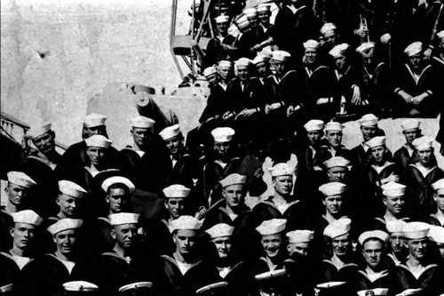 Close up of Chow Hoy in a shot of crew in the U.S. Navy