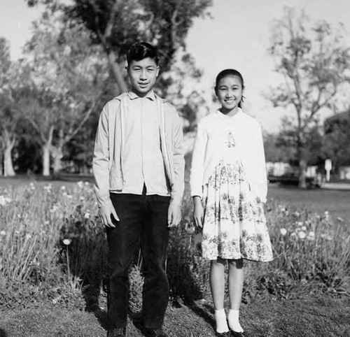 Henry and Susan Quan standing outside