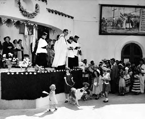 Christine Sterling behind the priest at Blessing of the Animals