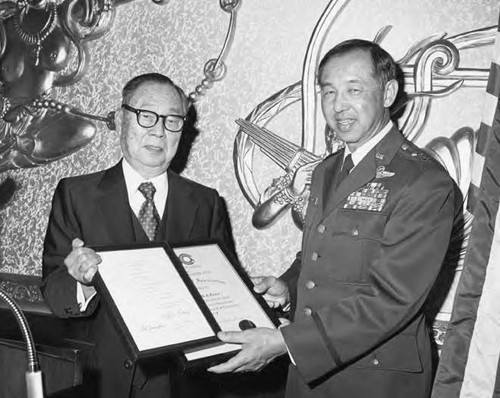 Dr. Stanley Chan presenting awards to Major General Dewey Lowe of the U.S. Air Force at the New Golden Shark Restaurant in Monterey Park