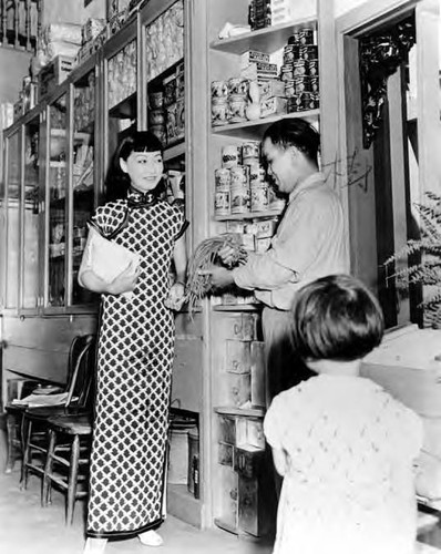 Anna May Wong at Chew Yuen Co. in Chinatown with Mr. Soo Hoo Shee Wing, owner of the store