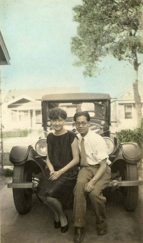 Grace Siu and Phil sitting on a car