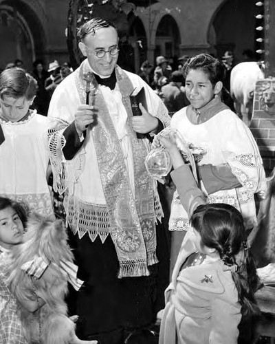 Priest blessing a goldfish at Blessing of the Animals