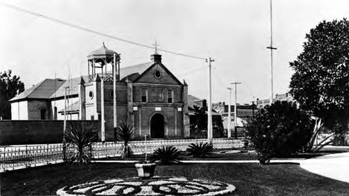 Plaza Church with gothic bell tower, and a portion of the Plaza showing