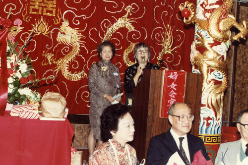 Speaker Lily Lum Chan standing at the podium