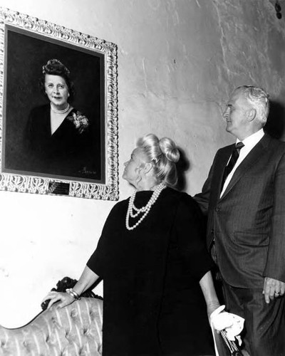 June and Jack Parks looking at Christine Sterling portrait