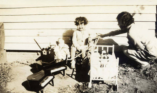 Shirley Siu sitting among a pile of toys in Riverside, California