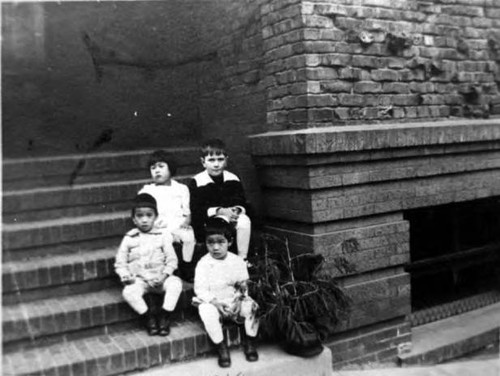 Four children on steps of 920 Sacramento