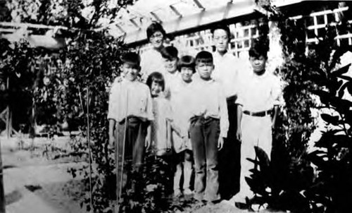 C: Closeup, the private Chinese school. Teacher in rear left, tallest