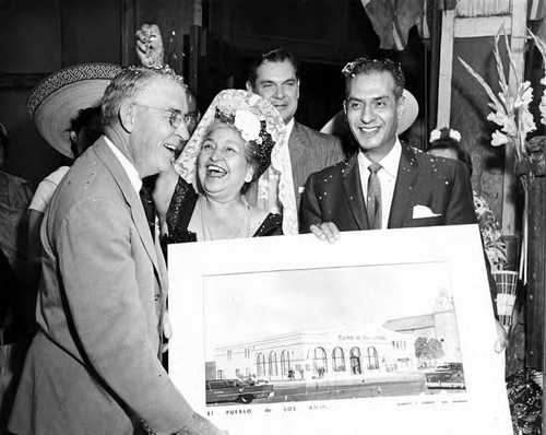 Consuelo de Bonzo, John Anson Ford, and Edward R. Roybal with a drawing of the Simpson building at the Simpson building opening