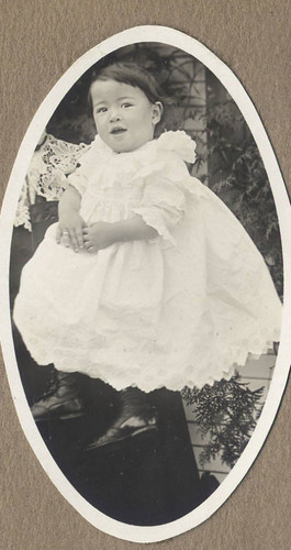 Jake as a child in a white christening dress