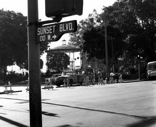 Workers closing street with Sunset Boulevard sign adjacent to them