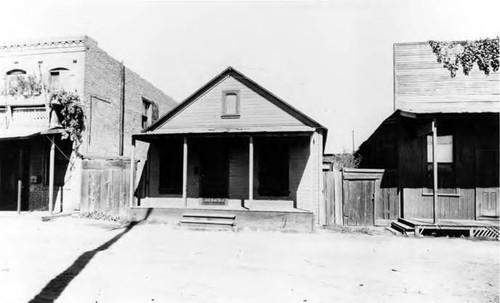 The house in the middle is Mr. Soohoo's house. The brick building is Mrs. Lew Jon's. The building was formally built by Wong Chong Tai in the early 1890's- 1910