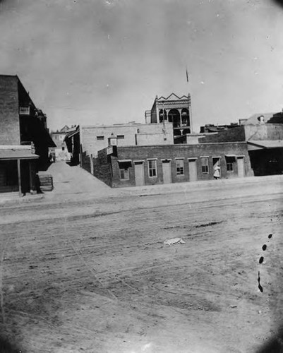 Los Angeles Chinatown. The view is looking west from Alameda Street toward the Plaza. Plaza Street, at the center distant left, runs west from Alameda to Main Street. The tall building at center faces Plaza on the east side, several doors south of the Lugo Adobe. The building at the distant center (with mulitple doors and windows) was part of the "crib district"--the contemporary name for houses of prostitution
