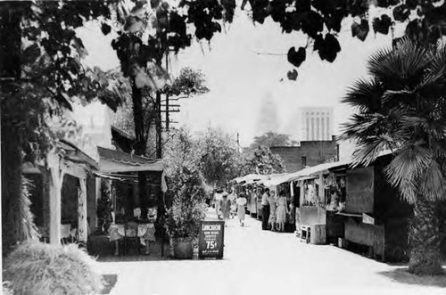 Photograph of booths along Olvera Street with City Hall in background