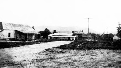 View of San Juan Capistrano with Mendelson Hotel in background. The house in the foreground is a Texaco station