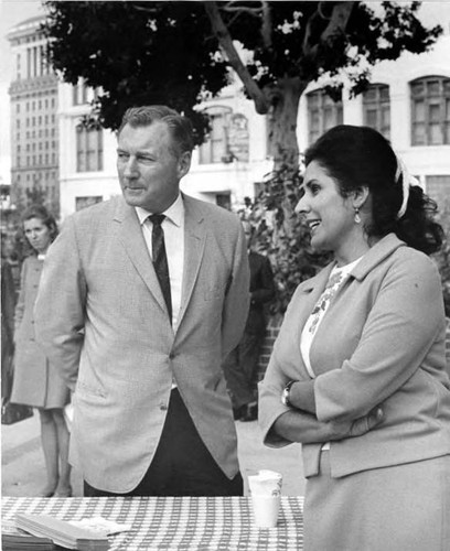 William Probert, El Pueblo Director, talking to a woman in the Plaza