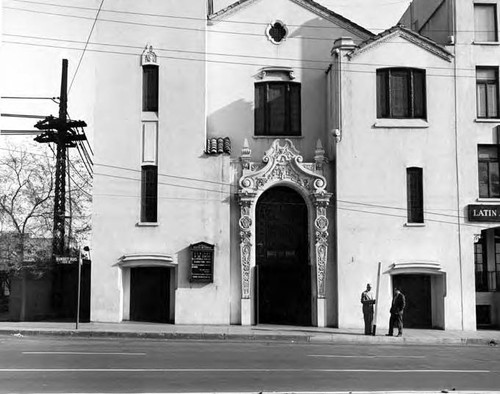 Sunset Boulevard facade of the Methodist Plaza Church with two men stainding in front