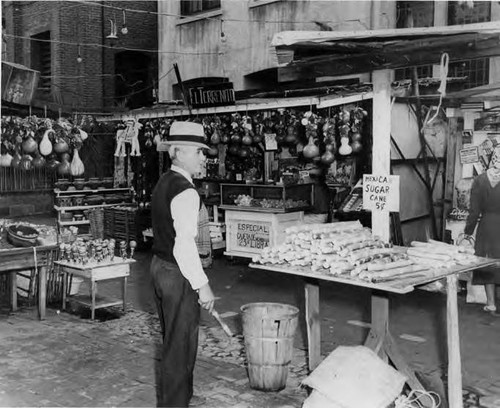 Man in front og booths on Olvera Street