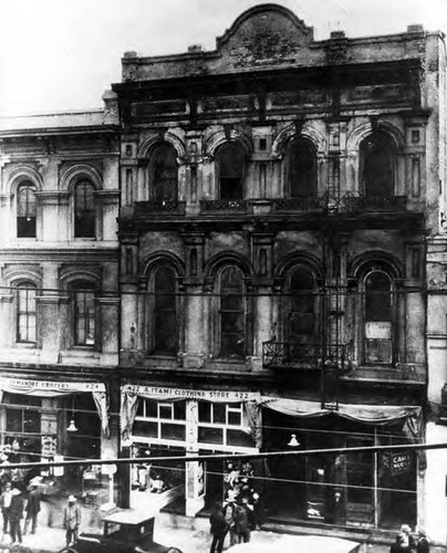 Photo of Merced Theater and portion of Pico House, pictured are the Itami Clothing Store at 422 Main and the Yamanobe Grocery at 424 Main, facade of the buildings are in dilipated state