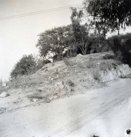 Photo of a dirt road on the back of which it reads "street side of lot" (Spencer Chan Family)