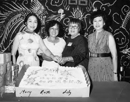 The tenth anniversary of New Life. Lily Chan and her co-workers stand in front of the cake