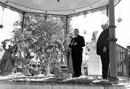 Nativity scene in kiosko; Consuelo de Bonzo, a Catholic Priest and a man in the lower right hand corner