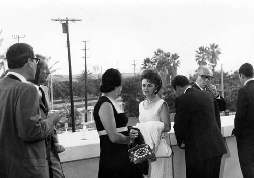 People talking by Biscailuz balcony wall at the reception for the President of Mexico