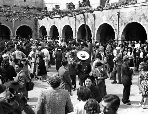 Crowd in patio during Blessing of the Animals