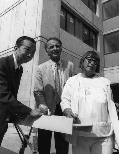 A ceremony at Cathay Manor, from left to right are Lewis Au, Ed Edelman and Lily Chan