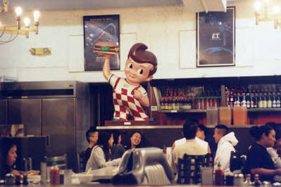 View of Bob's Big Boy statue inside Noodle Planet from the street in Alhambra, CA