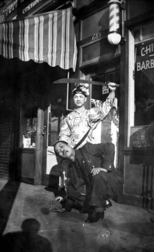 "Headchoppers" on Spring Street in front of a barber shop and to the left Tom's curio store, Tom G. costume