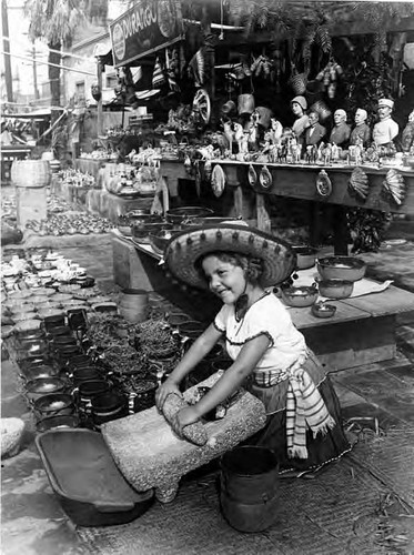 Little girl grinding corn