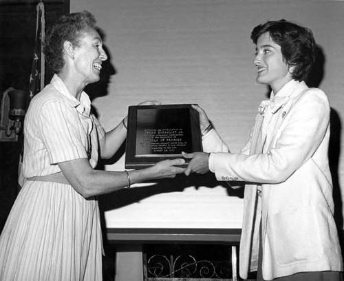 Jean Bruce Poole handing Efrem Zimbalist plaque to Maria Pollia at the premier showing of "Pueblo of Promise" film