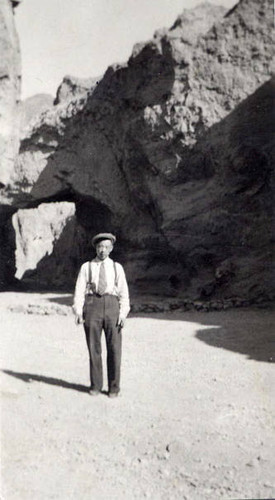 Photo of a Chinese American man posed in front of a rock formation