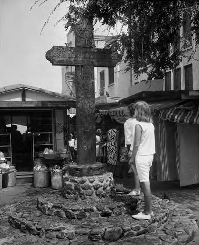 Two girls looking at cross