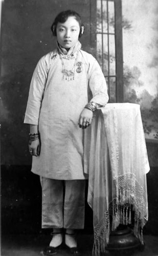 Mabel Lew 14 years old bedecked with Chinese real jewelry belongs to mother or aunt. This costume she wears for Chinese New Years or holidays