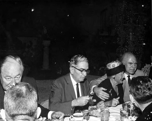 Hernando Courtright at table with Eugene Biscailuz and a woman