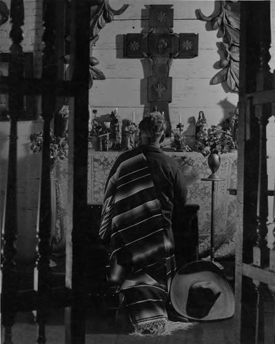 Man kneeling at altar, Avila Adobe