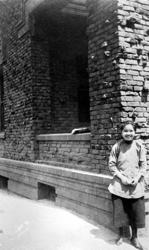 Woman in front of Cameron House, San Francisco (possibly Florence Hoy)