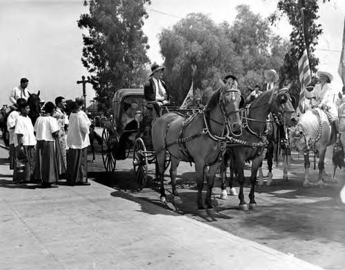 Horse drawn carriage in front of the priest during Blessing of the Animals