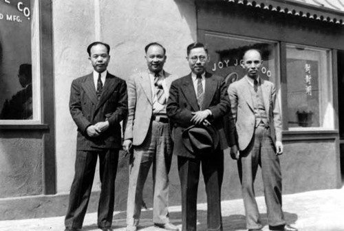 Peter Soo Hoo Sr. with New Chinatown merhcants at the Grand Opening. The merchant on the right is Lee Wah Sow, the owner of Yee Sing Chong Grocery Store