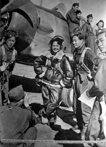 Togged out in full flying dress, complete with parachute and radio headset, 17 year old Frances Chan poses happily with a succession of Luke Field cadets. p.28