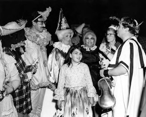 Girl surrounded by adults in costume