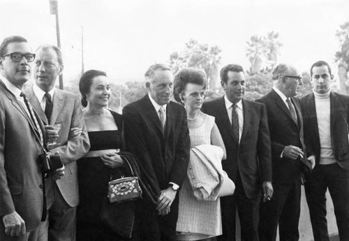 Six men and two women posed by Biscailuz balcony wall at the reception for the President of Mexico