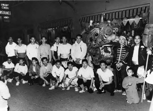 Group of young men posing with a dragon in front of Emory Chow Insurance Agency