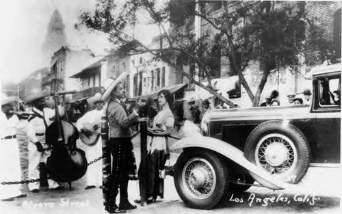 Man and woman at Macy Street entrance looking toward City hall, post card