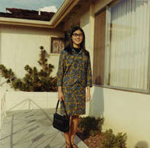 Susan Quan standing in front of a house